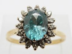 A 9ct gold ring set with an oval cut zircon surrounded by diamonds, size W, 4.