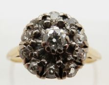 An 18ct gold ring set with diamonds in a cluster in a platinum setting, size N, 3.