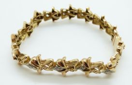 An 18ct bi-coloured gold bracelet set with 14 diamonds, each approximately 0.07ct, 28.
