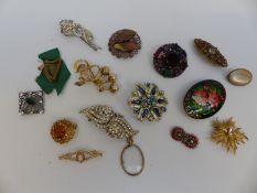 A collection of brooches to include Miracle brooch, lacquer brooch, diamante,
