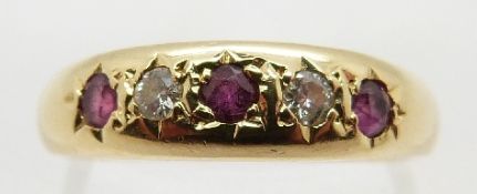 An 18ct gold ring set with alternating diamonds and rubies in a star setting, size L, 3.
