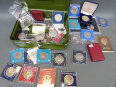 A metal cash box containing a collection of modern crowns and crown sized coins etc to include