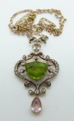 An early 20thC 9ct gold pendant set with a central shield-shaped peridot,