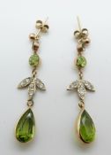 A pair of 9ct gold earrings each set with diamonds,