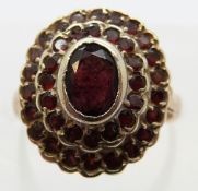 A 9ct gold ring set with garnets in a cluster, size J, 4.