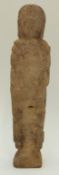 A medieval carved limestone Romanesque figure of a robed man holding a book,