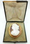 A large Victorian yellow metal brooch set with a shell cameo depicting a young woman,