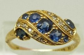 An 18ct gold Edwardian ring set with sapphires and diamonds in a twist setting, Birmingham 1909,