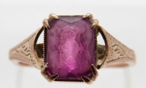 A 9ct gold ring with engraved shoulders set with a mixed cut pink sapphire, size M, 2.