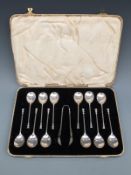 A cased set of 12 hallmarked silver seal topped spoons and nips,