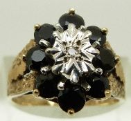 A 9ct gold ring set with diamond surrounded by sapphires, size O, 4.