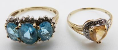 A 9ct gold ring set with a heart shaped citrine and a 9ct gold ring set with three oval cut blue