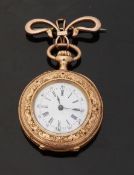 18ct gold keyless winding open faced fob watch on 9ct gold bow brooch,