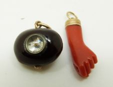 A Victorian carved coral charm in the form of a hand together with a seed set with a compass