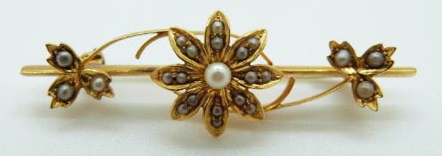 A 15ct gold Edwardian brooch set with seed pearls in a floral design, 3.