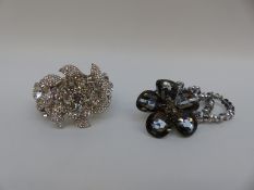 A large Butler & Wilson bangle set with paste in the form of a tiered flower and a Butler & Wilson