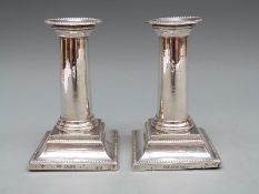 A pair of Victorian hallmarked silver candlesticks with square stepped base,