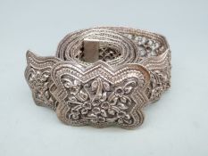 A white metal belt with filigree and embossed decoration, purchased by the vendor in Laos,