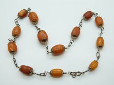 Hallmarked silver and amber necklace of 13 graduated ovoid beads of butterscotch and egg yolk