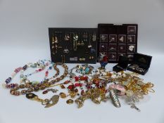 A collection of costume jewellery to include glass beaded necklace, badges, brooches,