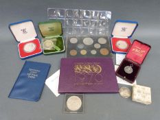 A collection of modern crowns and UK coin sets to include silver examples and a silver Scouting