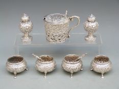 Indian white metal six piece cruet set comprising two peppers and four open salts all with embossed