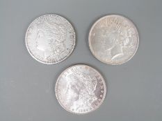 Two USA Morgan dollars 1884 and 1921 together with a 1928 Liberty example