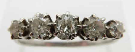 A platinum ring set with five old cut diamonds, the centre diamond approximately 0.2ct, size P, 2.