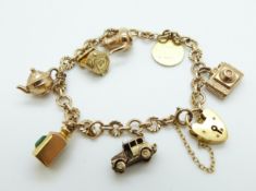 A 9ct gold charm bracelet with seven 9ct gold charms including St Christopher, wishing well,