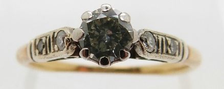 An 18ct gold ring set with a round cut diamond of approximately 0.