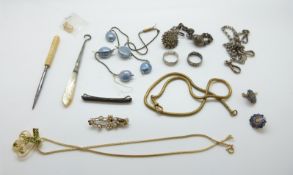 A silver bracelet with egg pendant, fob chain, buckle, enamel buttons,