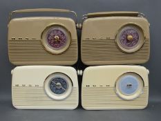 Two Bush TR82/97 three band portable radios together with two Bush TR82 three band portable radios