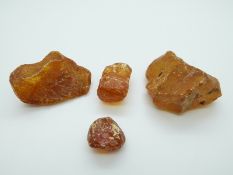 Four pieces of raw uncut copal amber, largest 54 x 32 x 47mm, 72g.