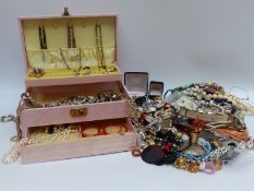 A quantity of costume jewellery including shell pendants, beaded necklaces,