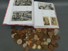 A small collection of coins including silver content, banknotes, postcards and cigarette cards,