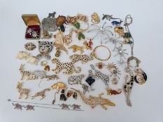 A large collection of brooches including ten leopard paste brooches some by Sardi,