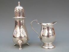 A silver hallmarked sugar sifter with pierced top and lion mask feet, London 1977, height 16cm,