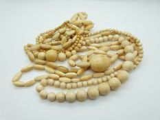 Four carved ivory bead necklaces of variously shaped beads, the largest 36.7 x 25.