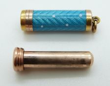 A 9ct gold charm set with aqua guilloché enamel revealing a propelling pencil,