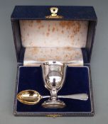 A cased hallmarked silver egg cup and spoon set Birmingham 1969, maker S J Rose & Son,
