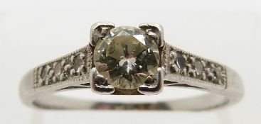 A platinum ring set with a round cut diamond of approximately 0.