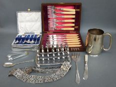 A plated pierced nurse's belt, heavy toast rack, cased spoons,