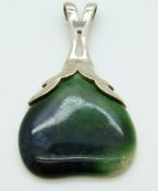 An Arts & Crafts silver pendant set with a blue and green Ruskin cabochon
