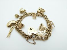 A 9ct gold charm bracelet with 10 charms including a church opening to reveal a ceremony, a boat,
