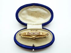 A 9ct gold brooch set with diamonds and rubies,