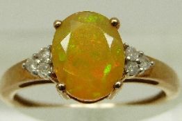 A 9ct gold ring set with yellow opal and diamonds, size N, 1.8g.