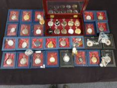 A collection of collectable modern pocket watches together with a group of miniature clocks,