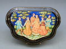 A shaped Russian lacquer box, width 18cm,