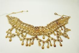 An Indian yellow metal necklace with drop sections, 44.