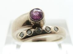 An 18ct white gold ring set with a pink sapphire and diamonds, size L, 6.